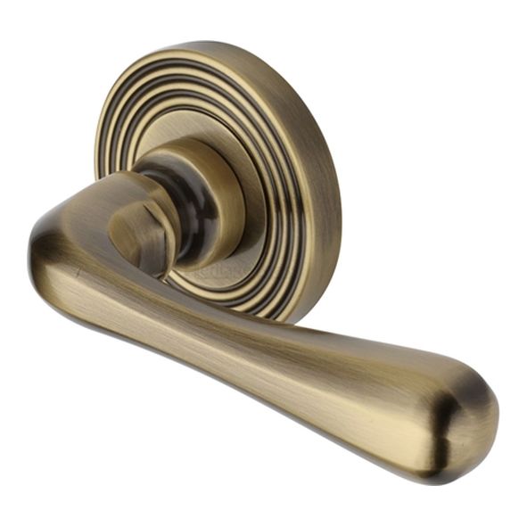 RR3022-AT • Antique Brass • Heritage Brass Charlbury Reeded Lever Furniture on Round Rose