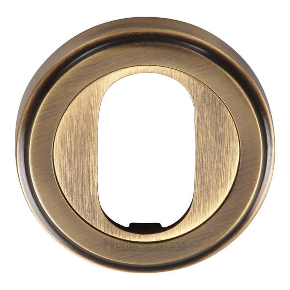 V5010-AT • Antique Brass • Heritage Brass Edged Round Oval Cylinder Escutcheon